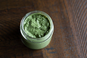 lavender matcha mask open, showing mask texture, on a tabletop