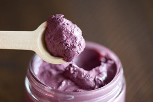 close up of the Olivia's Organics hibiscus face mask in a spoon with the jar in the background